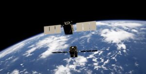 Two satellites orbiting Earth in space.