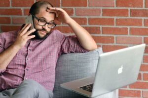 Man frustrated with a slow laptop`