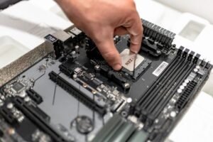 Person working with laptop hardware