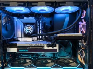 Person working inside a gaming PC with GPU and memory components
