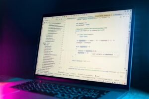 Laptop screen displaying lines of code, representing the technical work behind Anthropic's AI misuse report