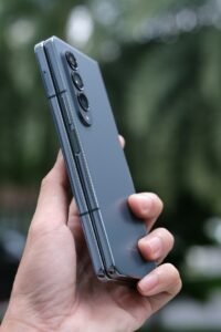 Person holding an open Samsung Galaxy Z Fold smartphone
