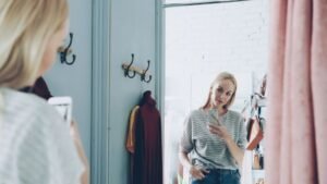 ChatGPT virtual try-on: woman taking a selfie on her phone in a changing room mirror