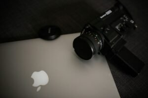 Camera resting on a laptop, a reminder to keep a second backup copy of your photos
