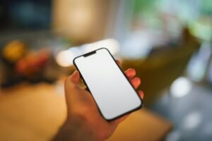 Hand holding a smartphone as Samsung Gallery stops syncing with OneDrive