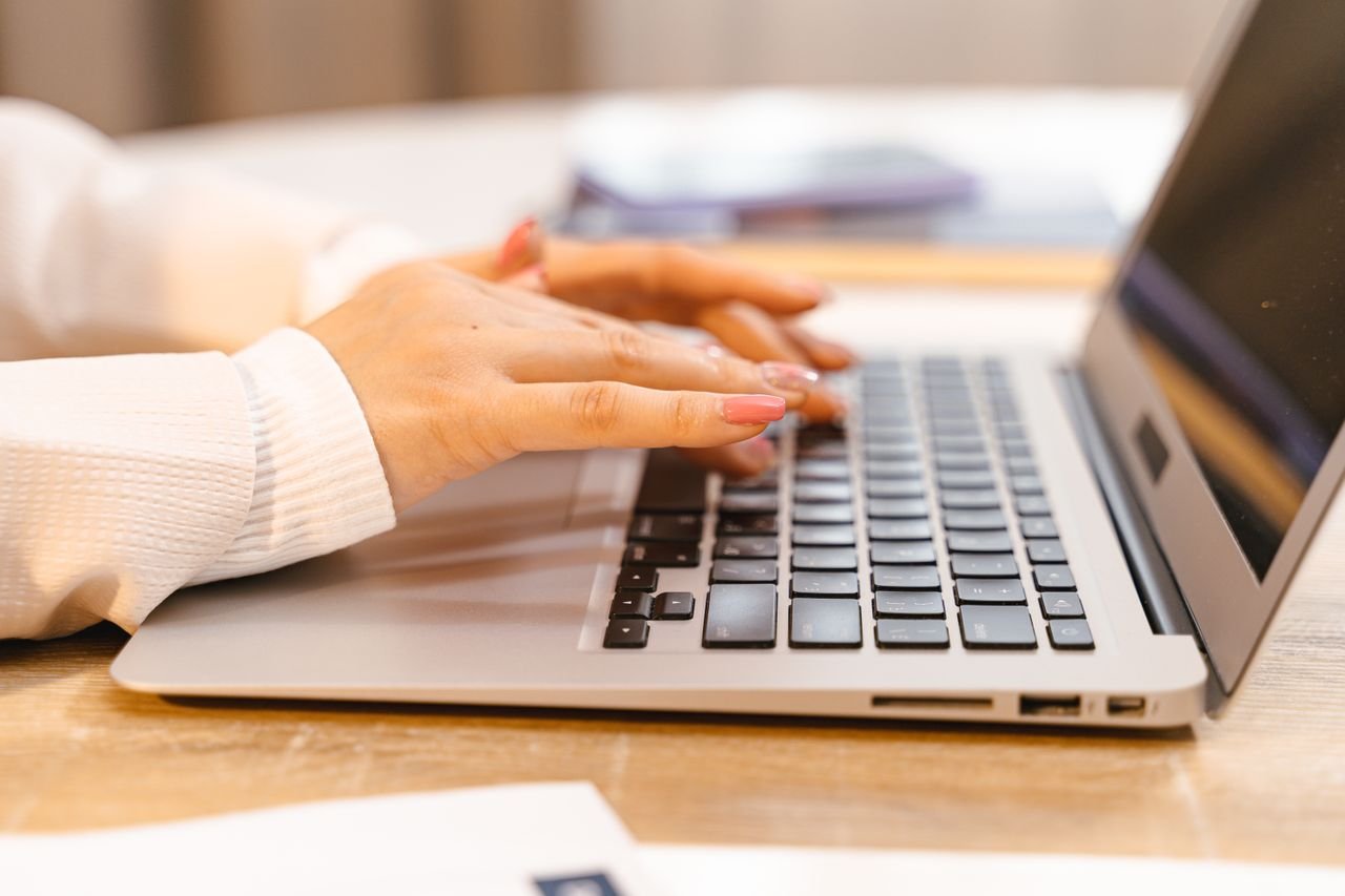 Person typing on a laptop at a desk